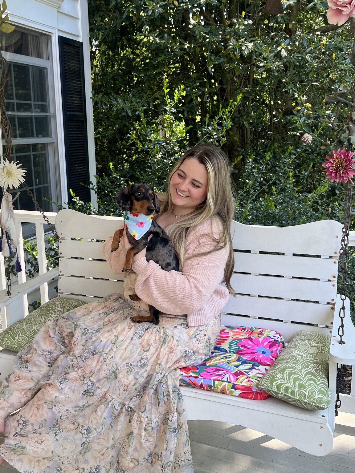 Kami holding a miniature dachshund
